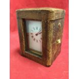 A cased Edwardian French made carriage clock, the leather box with original glass housing a brass