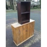A pine cupboard with tongue & groove doors supported on plinth; and a small stained pine open