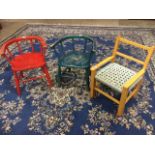 A pair of elm childs chairs with bow backs on spindles above solid seats, raised on turned legs &