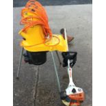 An Al-ko Kober electric garden shredder on three angled legs; and a Stihl SF45 petrol strimmer. (2)