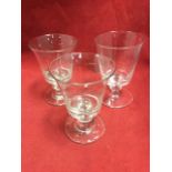 A pair of nineteenth century glass rummers with bell shaped bowls on knopped stems and thick