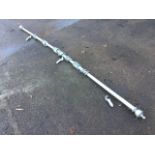 A painted 9ft 6in curtain pole with turned ends, complete with rings and wall brackets. (114in)