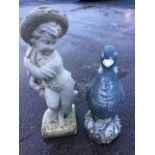 Two composition stone garden figures - a young boy and a goose. (2)