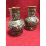 A pair of late nineteenth century Japanese bronze vases enamelled in red, blue & turquoise, having