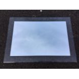 A rectangular contemporary bathroom mirror, the bevelled plate with glass border. (27.5in x 19.5in)