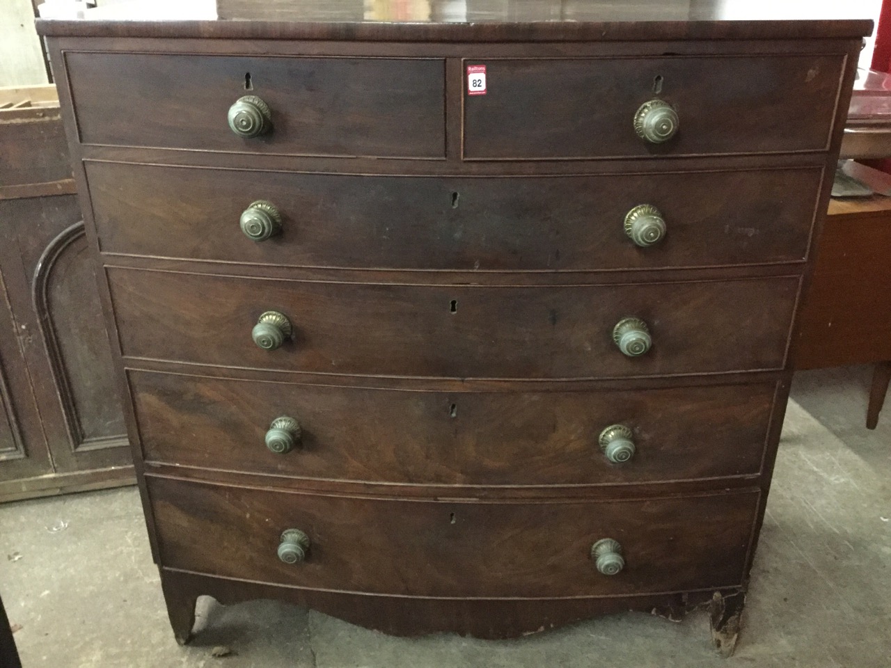 A nineteenth century mahogany bowfronted chest of drawers, with two short and four long cockbeaded