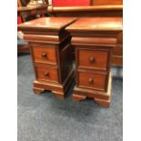 A pair of mahogany bedside cabinets, each with cushion moulded friezes above two panelled knobbed