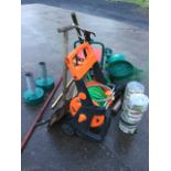 A quantity of gardening items including a hose reel, snow shovels, watering cans, lawn edging,