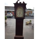 A nineteenth century mahogany longcase clock with swan-neck blind fretwork pediment above an