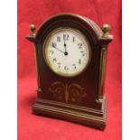 An Edwardian mahogany mantle clock, the domed case with brass corner pillars and ball finials having