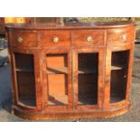 A bowfronted Victorian mahogany side cabinet with four cockbeaded frieze drawers mounted with