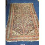 An antique eastern rug with multi-floral grid on ink blue field, the spandrels with flowerheads on