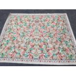 A 1952 Kilmarnock woven rug, with floral panel of autumn leaves within a linked scrolled