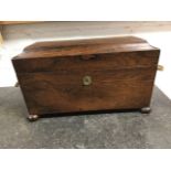 A nineteenth century rosewood tea caddy of sarcophagus tapering form mounted with brass ring