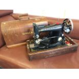 A walnut cased Singer sewing machine, the domed box with ribbed handle.