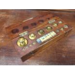 A mahogany cased set of Baird & Tatlock brass gram weights, the fitted box complete with