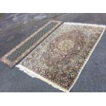 A pale finely woven oriental rug having central scalloped floral medallion with pendants on charcoal