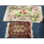 A hand knotted wool floral fireside rug with scroll entwined flowers on pink ground; and a small