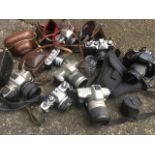 A collection of cameras - Hanimex Praktica, Ilford, leather cased, Kodak, Halina, lenses,