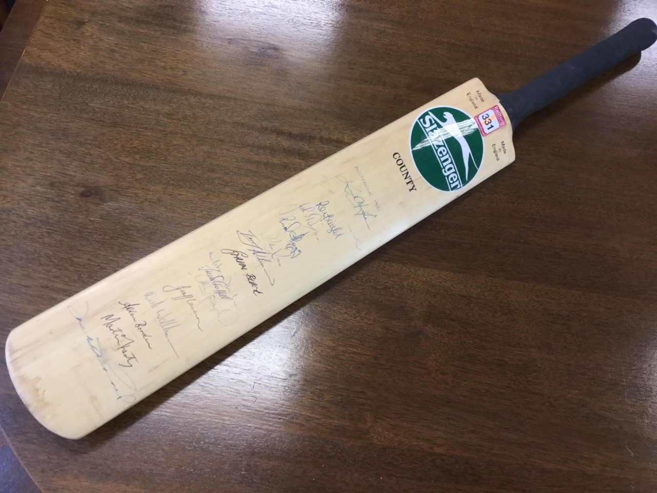 A Slazenger cricket bat signed by the Australian 1981 cricket team, with two county teams signatures