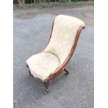 A Victorian mahogany chair with leaf scrolled carved frame, the sprung seat on floral carved