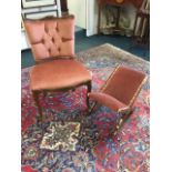 A upholstered side chair with floral scroll carved back rail above a brass studded button