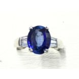 An 18ct gold sapphire & diamond ring, the oval claw set sapphire weighing over four carats,