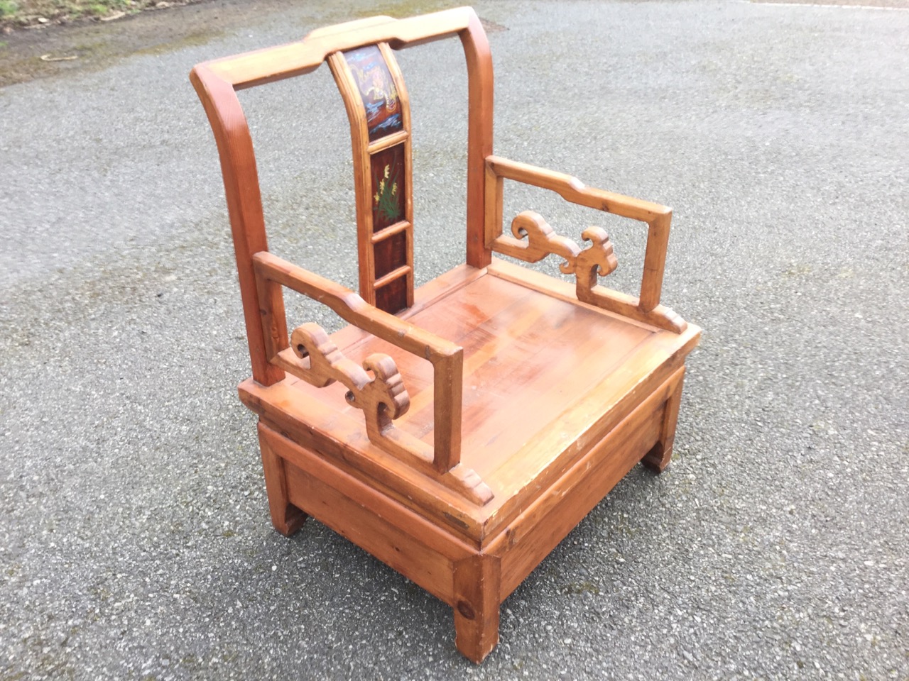 A Chinese armchair in pine, having yoke back rail above splat with framed painted panels, the square