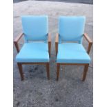 A pair of modern Morgan beech armchairs, with upholstered backs above cushion seats, having platform
