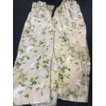 A pair Colefax & Fowler floral curtains, lined and interlined, printed with white roses and green