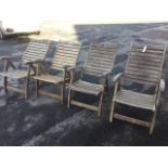 A set of four teak reclining armchairs by Land of Leather, the folding seats of slatted construction