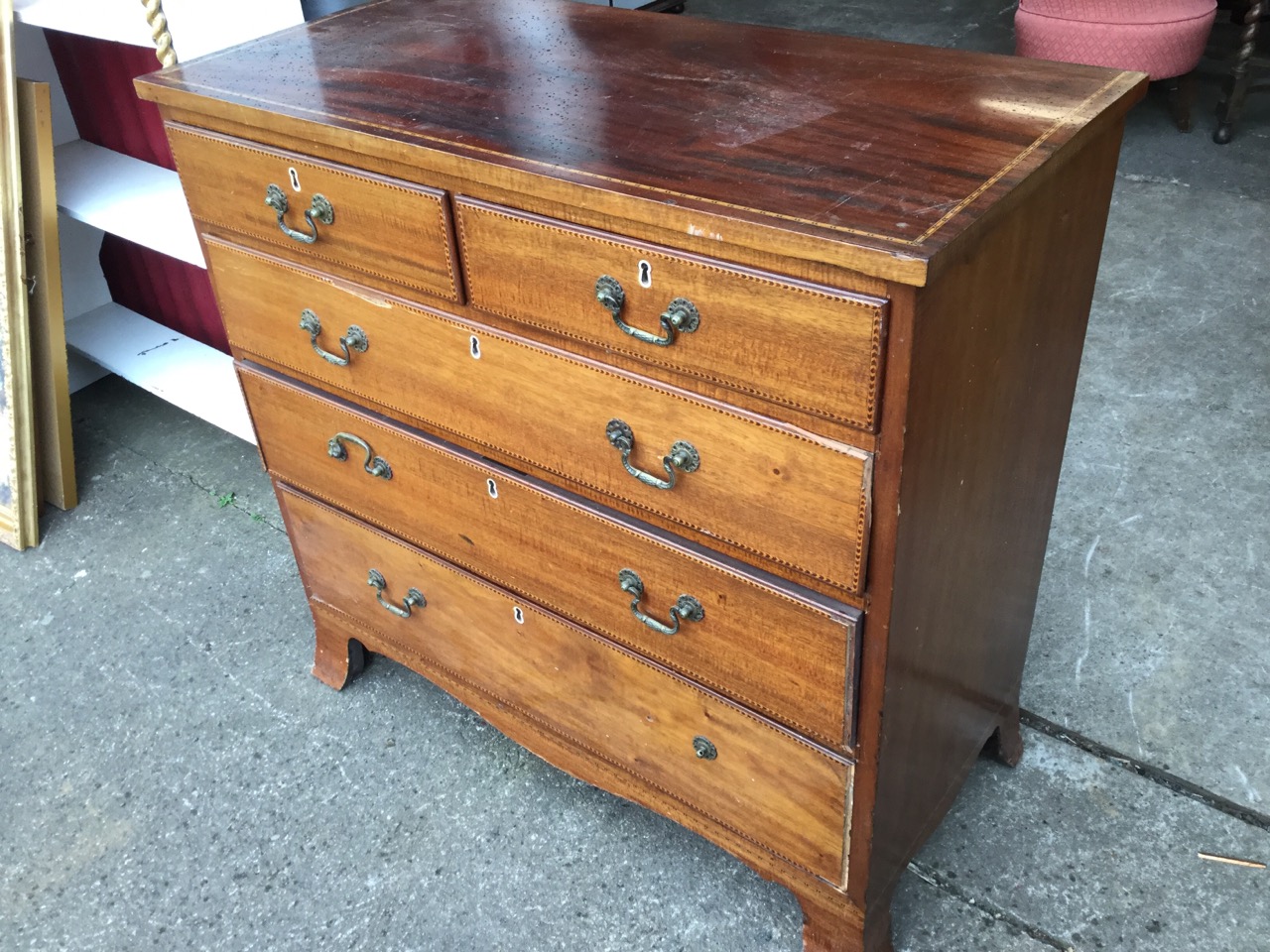 A nineteenth century mahogany chest of drawers decorated with chevron chequered boxwood & ebony