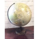 A 1959 Phillips Challenge globe on stand, having chromed axis arch revolving on tapering hardwood