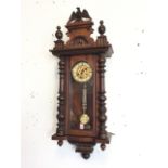 A Victorian walnut Vienna wallclock, having eagle crest above a pediment with applied arched
