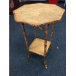 An octagonal burnt bamboo occasional table, with tray top on cane legs joined by square platform