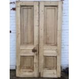 A pair of nineteenth century pine panelled doors, the rebated doors each with twin moulded panels