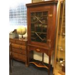 An Edwardian boxwood strung mahogany corner cabinet, the cornice with greek key and dentil