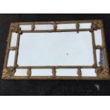 A nineteenth century gilt framed mirror, the ribbed frame having floral leaf mounts to separate