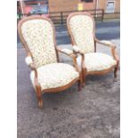 A pair of Victorian upholstered spoonback armchairs, the floral tapestry upholstery with brass