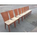 A set of eight contemporary dining chairs, the tapering backs pierced with grids of squares, above