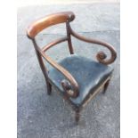 A nineteenth century mahogany elbow chair with curved back above a rexine upholstered studded seat
