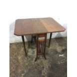 An Edwardian walnut sutherland table, the moulded top with canted corners having two hinged leaves