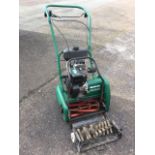 A Qualcast classic petrol 35 mower; and a scarifying attachment. (2)