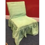 A Cintique upholstered chair with sprung seat, raised on rectangular tapering legs, fitted with