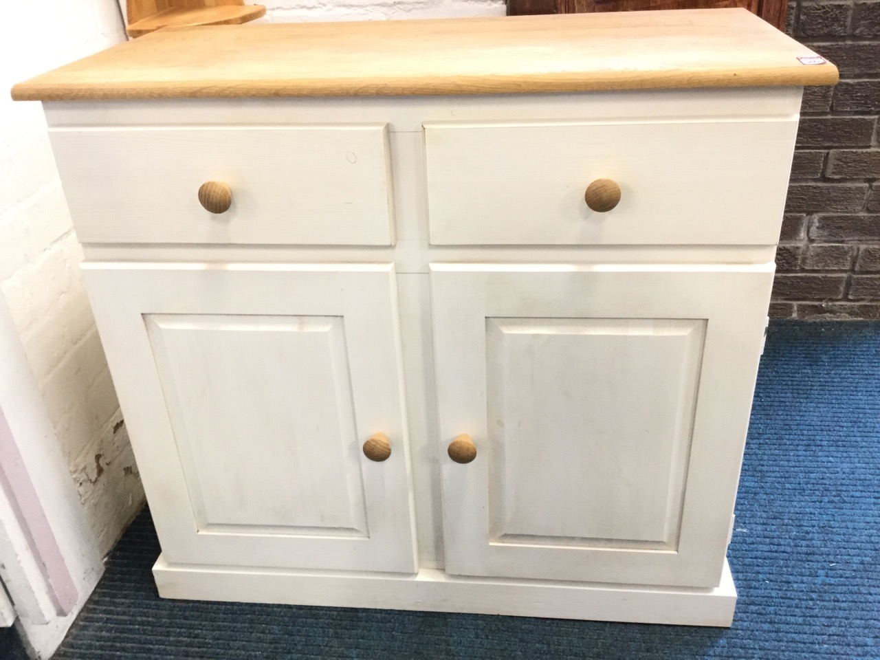 A contemporary painted cabinet with rectangular oak top above two drawers and two fielded panelled