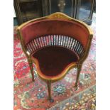 A late Victorian mahogany saloon chair, the rounded back with inlaid stringing having foliate