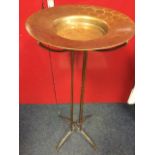 A contemporary platter on stand, the brassed dish with flared rim on circular support, with four