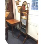 An Edwardian mahogany cheval mirror, with arched cushion moulded frame supported on square columns
