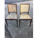 A pair of nineteenth century caned chairs, the backs with moulded frames above tapering seats,