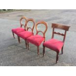 A set of three Victorian mahogany balloon-back dining chairs with stuff-over upholstered seats